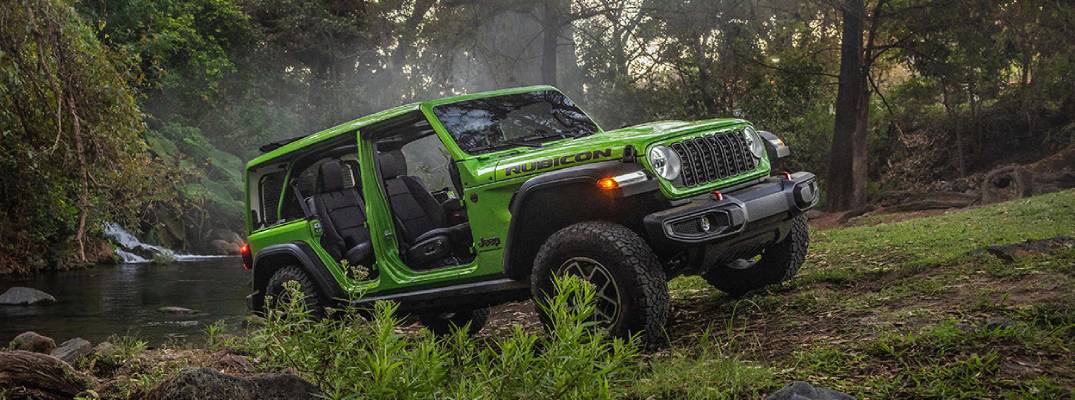 2026 Jeep Wrangler driving through grass