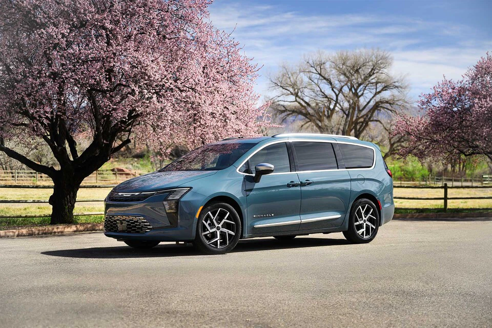 2027 Chrysler Pacifica parked on pavement next to trees
